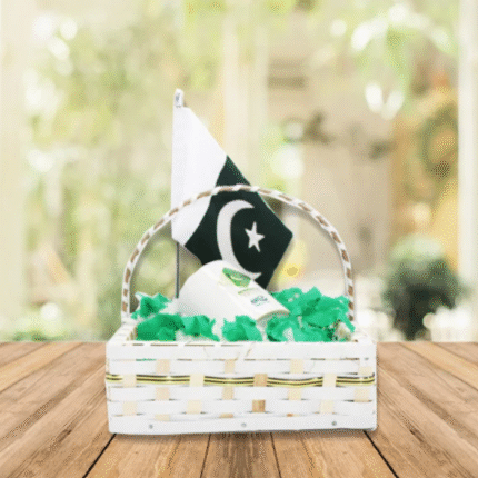 Independence Day gift basket featuring a polo shirt, dupatta, patriotic badges, bangles, table flag, wristband, and themed cupcakes, all arranged in decorative net packaging – perfect for celebrating 14th August in Pakistan